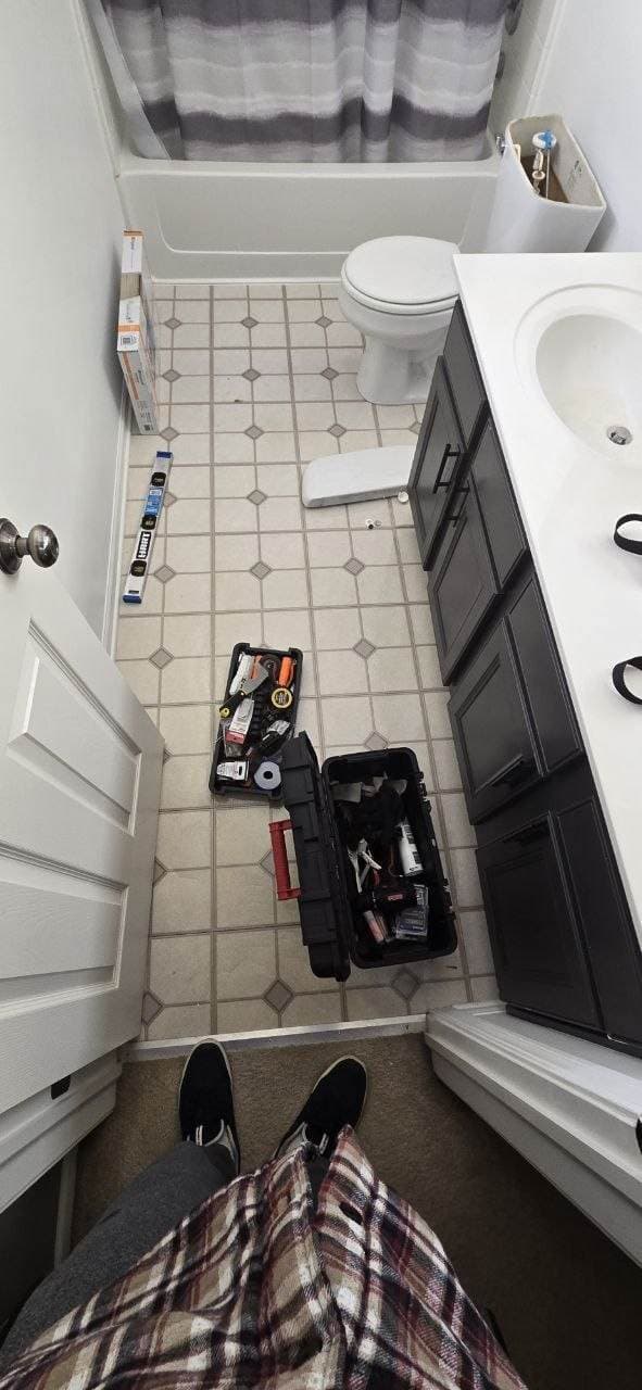 Bathroom floor before tile installation with tools prepared for remodeling by BAX