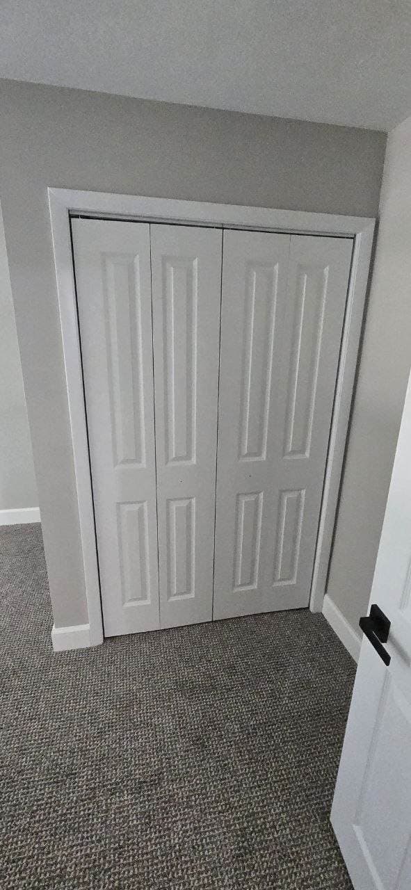 White closet bifold doors installed with finished trim by BAX in Hoffman Estates