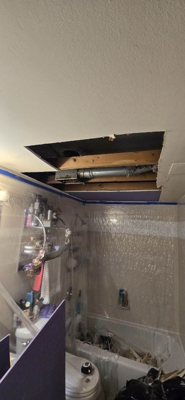 Bathroom ceiling drywall opening before repair work by BAX